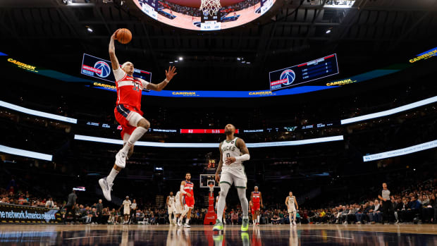 Nov 20, 2023; Washington, District of Columbia, USA; Washington Wizards forward Kyle Kuzma (33) prepares to dunk the ball as Milwaukee Bucks guard Damian Lillard (0) looks on in the third quarter at Capital One Arena. © Geoff Burke-USA TODAY Sports